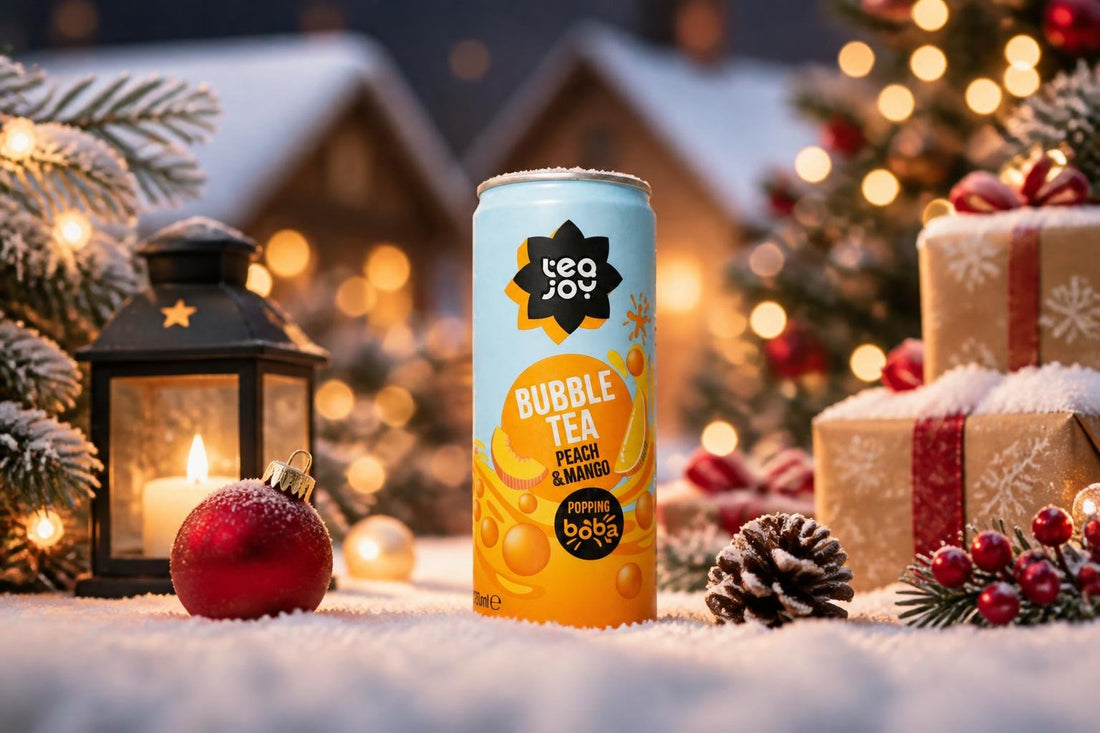 A TeaJoy Peach & Mango bubble tea can in a festive Christmas scene