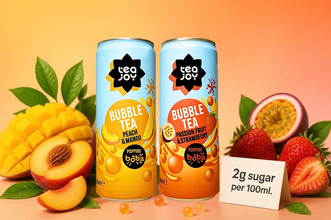 Two TeaJoy bubble tea cans with fruit and a card reading 2g sugar per 100ml